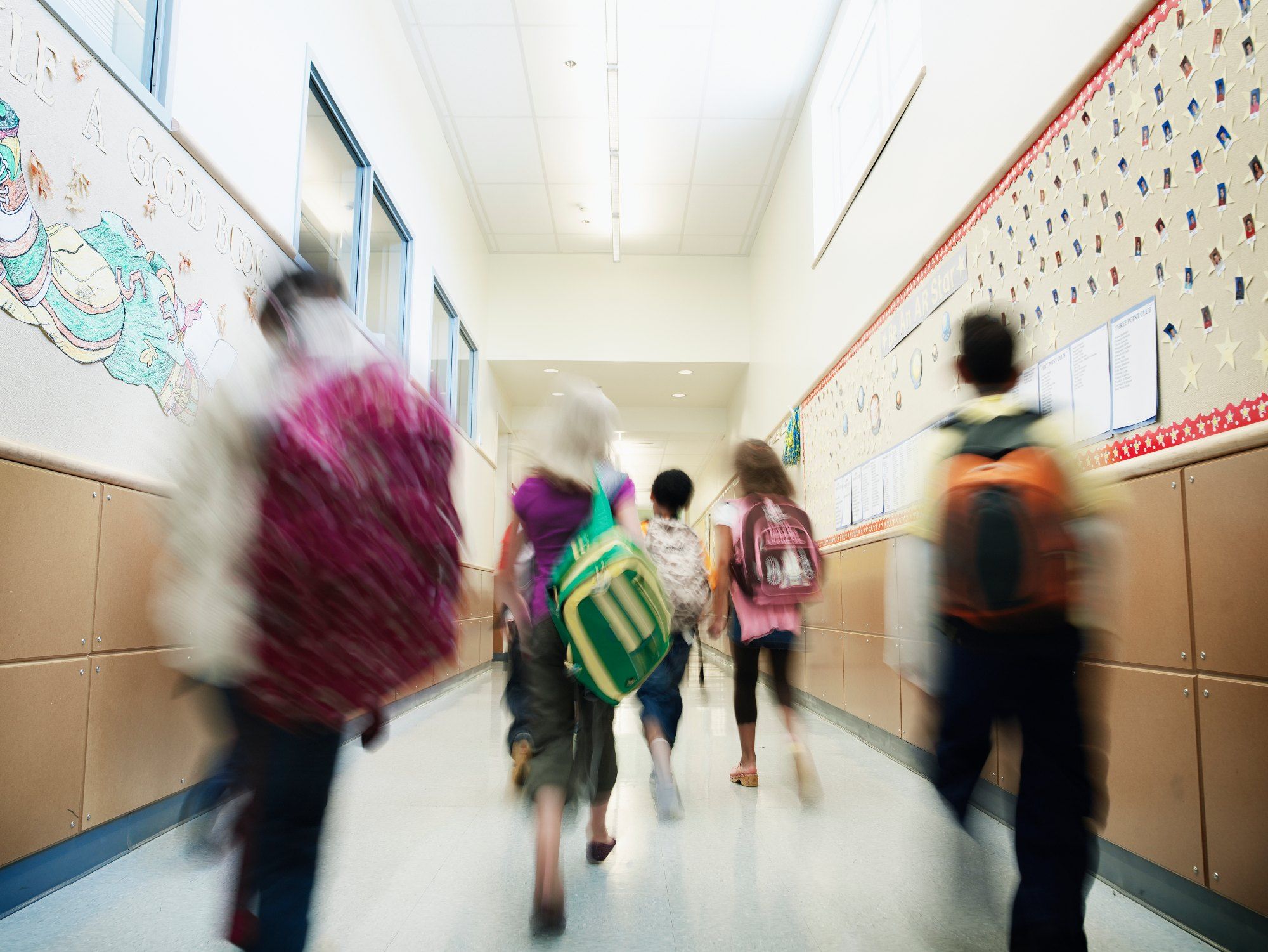 Young students walking down hallway of elementary school