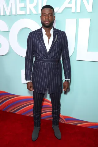 Sinqua Walls stops for pictures on the red carpet. - (Photo by Leon Bennett/Getty Images for BET)