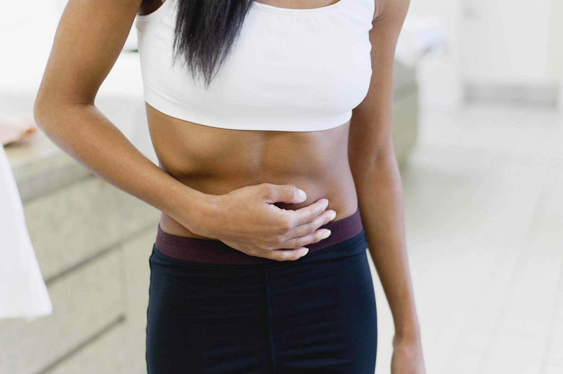 woman holding her stomach