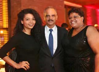 Holding a Piece of History - Attorney General Eric Holder and his guests share a warm embrace while taking a picture.  (Photo: Phelan Marc/BET)