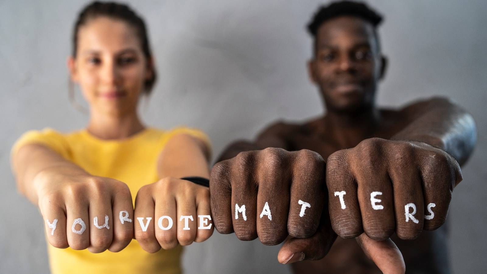 Friends showing their fists with the slogan "Your vote matters"