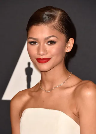 Getting Deep - A deep side part and low chignon make her pretty features pop at last year’s Academy of Motion Picture Arts and Sciences' Governors Awards.  (Photo: Frazer Harrison/Getty Images)