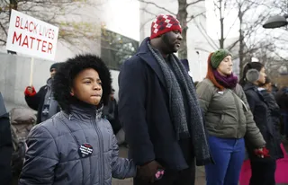 Praying for Peace - Marchers hold hands during a prayer. (Photo: REUTERS /JIM BOURG /LANDOV)