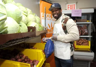Good Works - 50 Cent&nbsp;helps bag food for needy families at the&nbsp;Feeding America Bi-Coastal Celebrity Volunteer Event at Harlem Communiy Kitchen &nbsp;in New York City.(Photo: D Dipasupil/Getty Images for Feeding America)