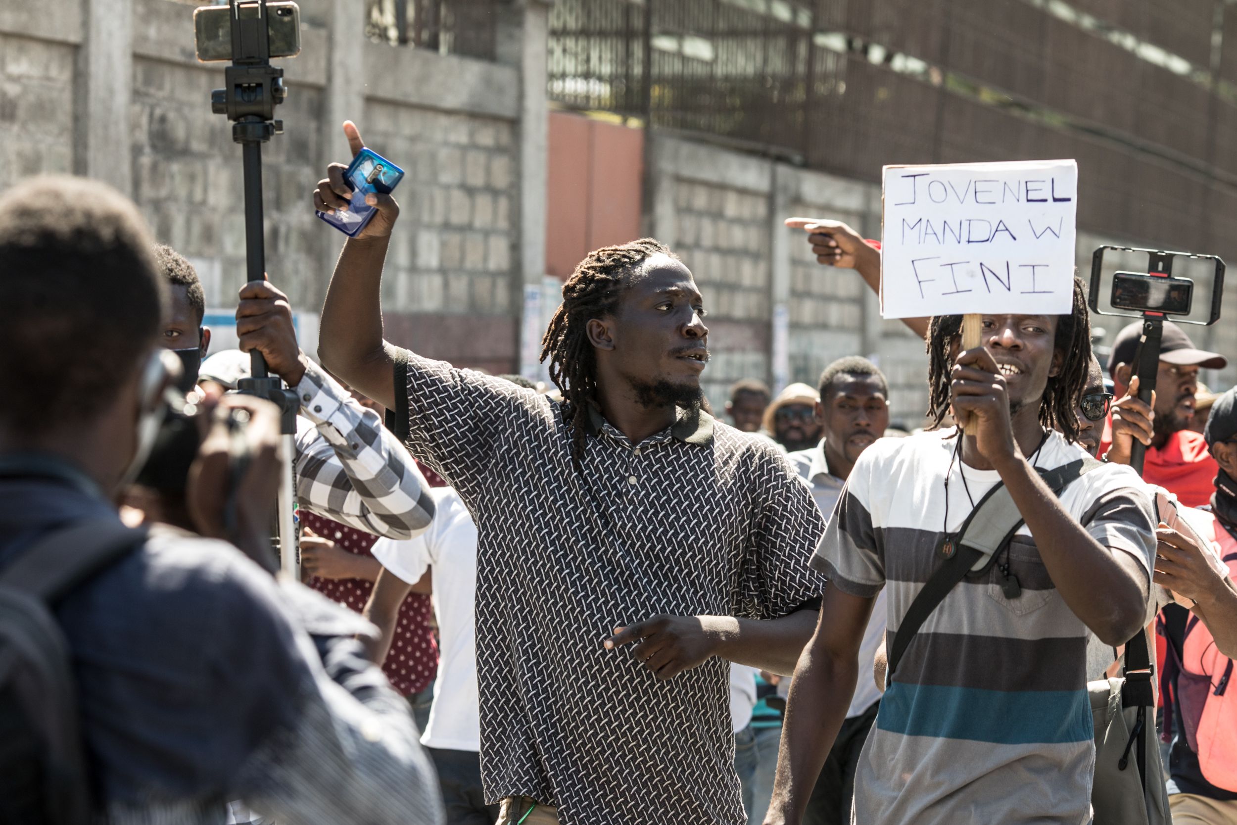 Demonstrators march in Port-au-Prince on February 10, 2021, to protest against the government of President Jovenel Moise. - Haitian police fired tear gas on hundreds of protesters who were marching against President Jovenel Moise and attacked journalists covering the demonstration, in the latest clashes to mark the country's political crisis. The protesters were accusing Moise of illegally extending his term. He says it lasts until February 2022 -- but the opposition argues it should have ended last weekend, in a standoff over disputed elections. (Photo by Valerie Baeriswyl / AFP) (Photo by VALERIE BAERISWYL/AFP via Getty Images)