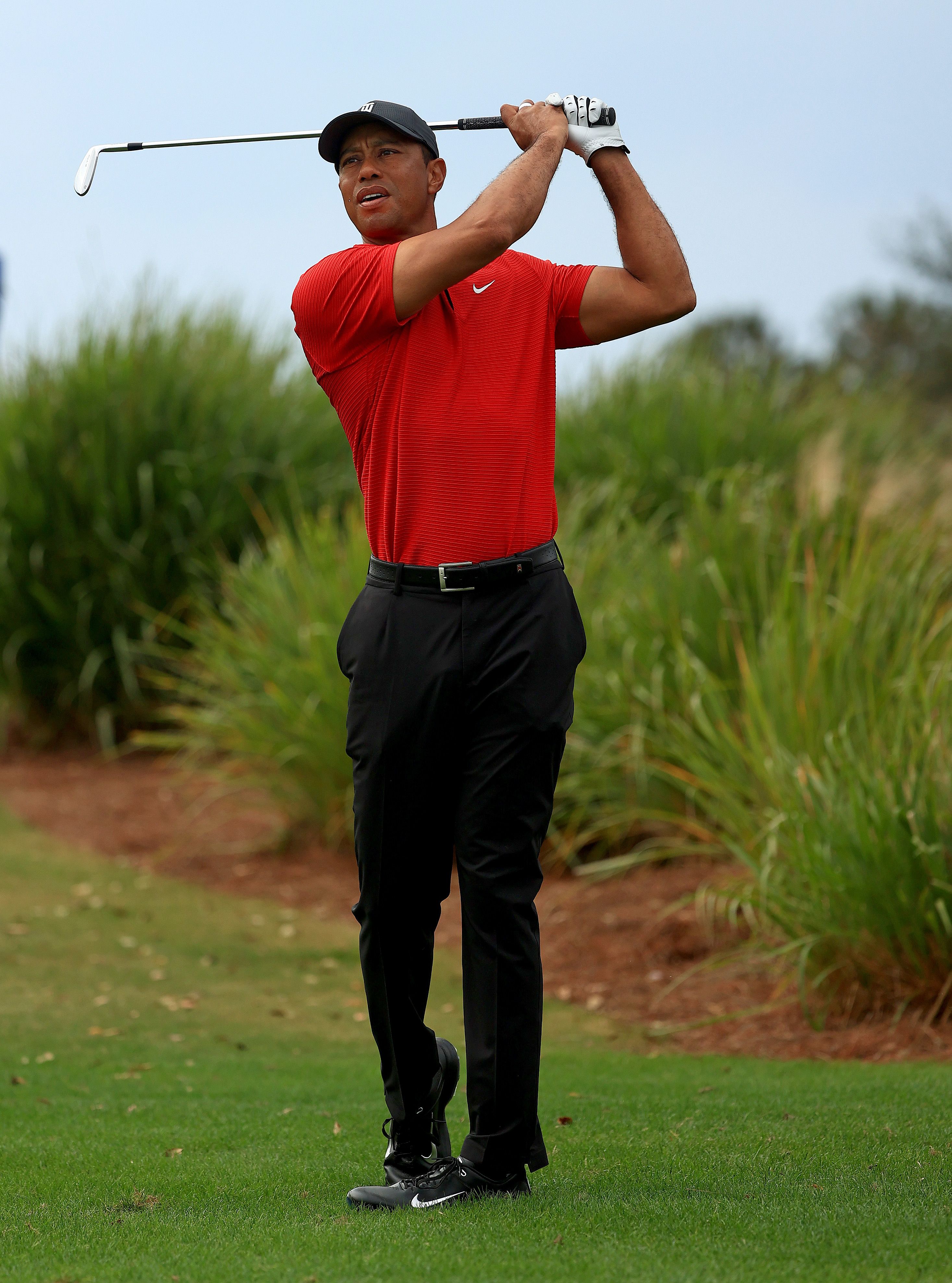 ORLANDO, FLORIDA - DECEMBER 20: Tiger Woods of the United States hits his approach shot on the 16th hole during the final round of the PNC Championship at the Ritz Carlton Golf Club on December 20, 2020 in Orlando, Florida. (Photo by Mike Ehrmann/Getty Images)