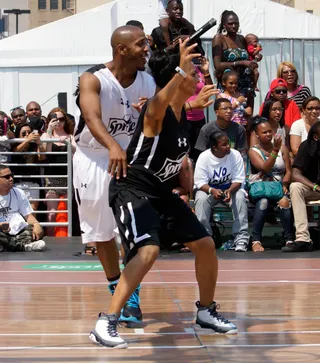 Ballin' in the Paint - Marques Houston learned that reality star Laura Govan is not your average basketball wife. Govan showed the R&amp;B singer some of her moves in the paint.(Photo: Ben Horton/Getty Images for BET)