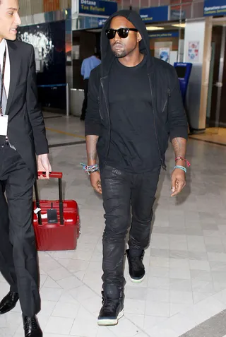 Kanye West - An all-black everything look with shades is one easy way to keep it sharp at the airport.  (Photo: ANG/Fame Pictures