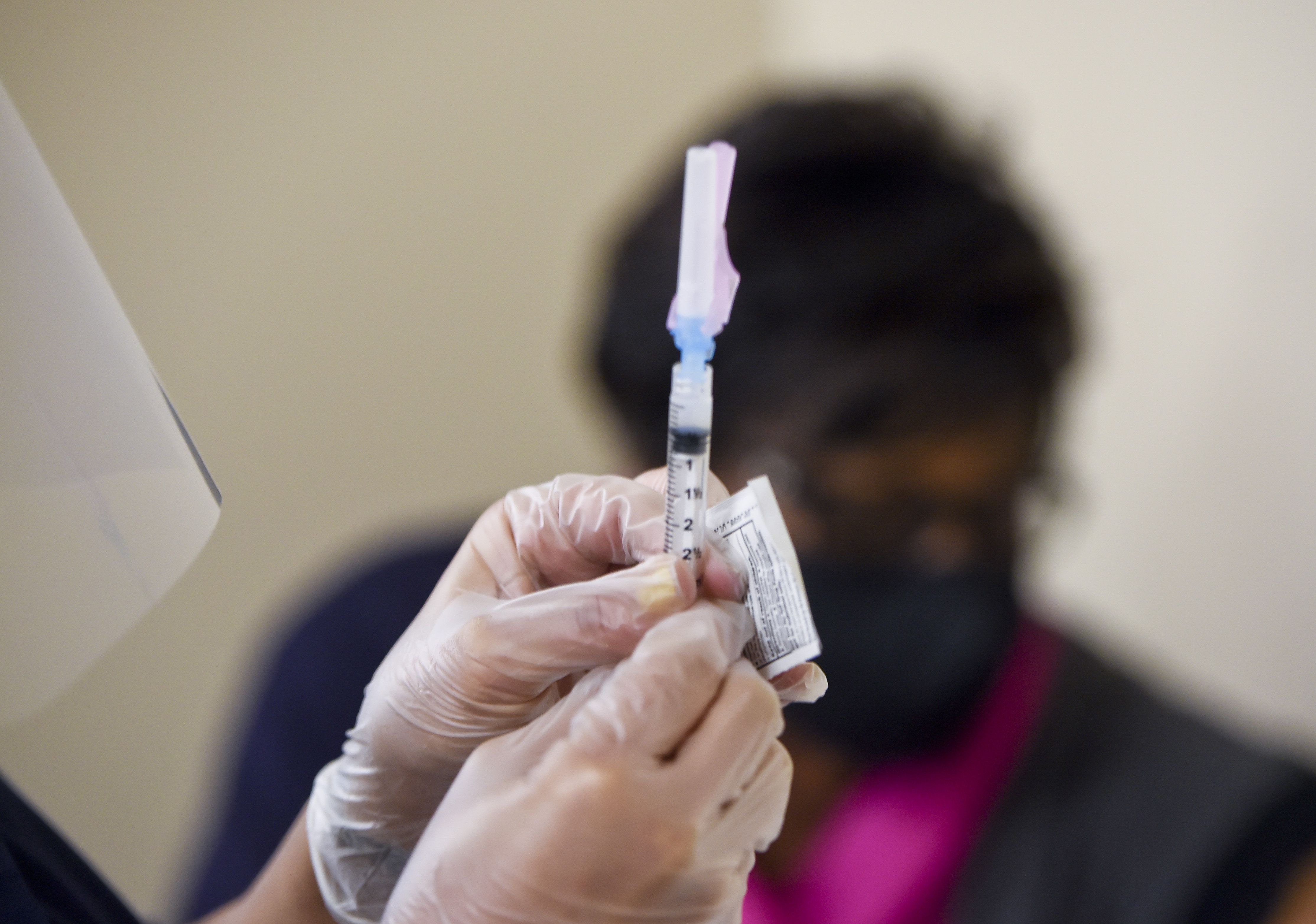 CMA Mia Alicea holds a syringe as she prepares to administer a dose of the Moderna COVID-19 vaccine. At the Berks Community Health Center in Reading Wednesday afternoon January 6, 2021, where they were administering the Moderna COVID-19 Vaccine to staff and other healthcare workers.