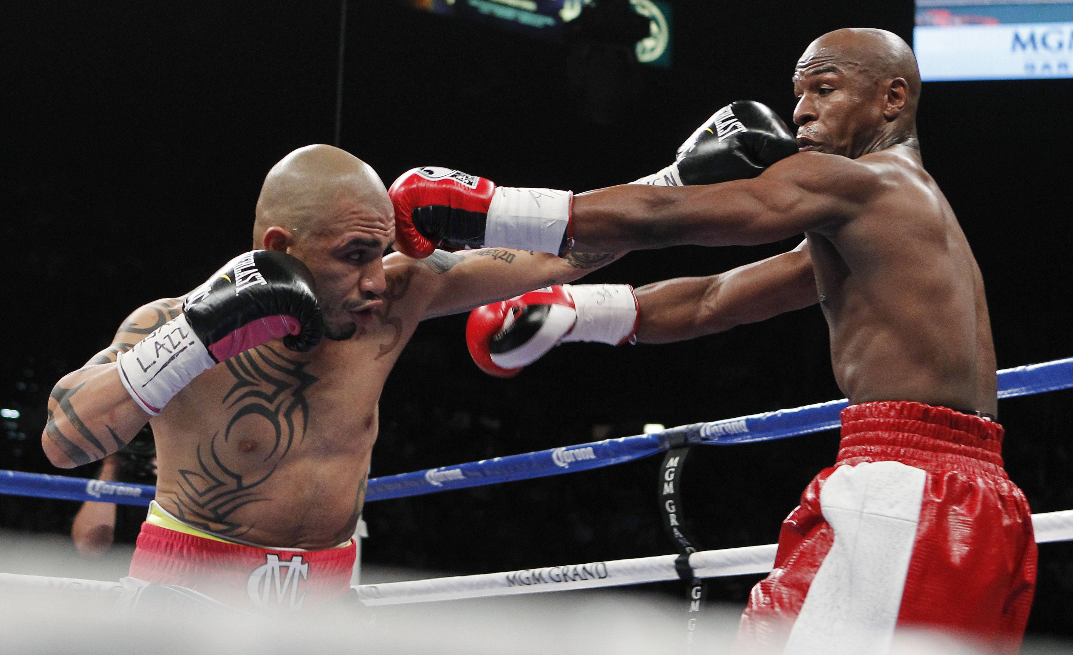 Trading Blows - Cotto exchanges punches with Mayweather in the first round of their match.&nbsp;&quot;You're a hell of a champion,&quot; Mayweather told Cotto after the match, writes the Associated Press. &quot;You're the toughest guy I ever fought.&quot;(Photo: AP Photo/Isaac Brekken)