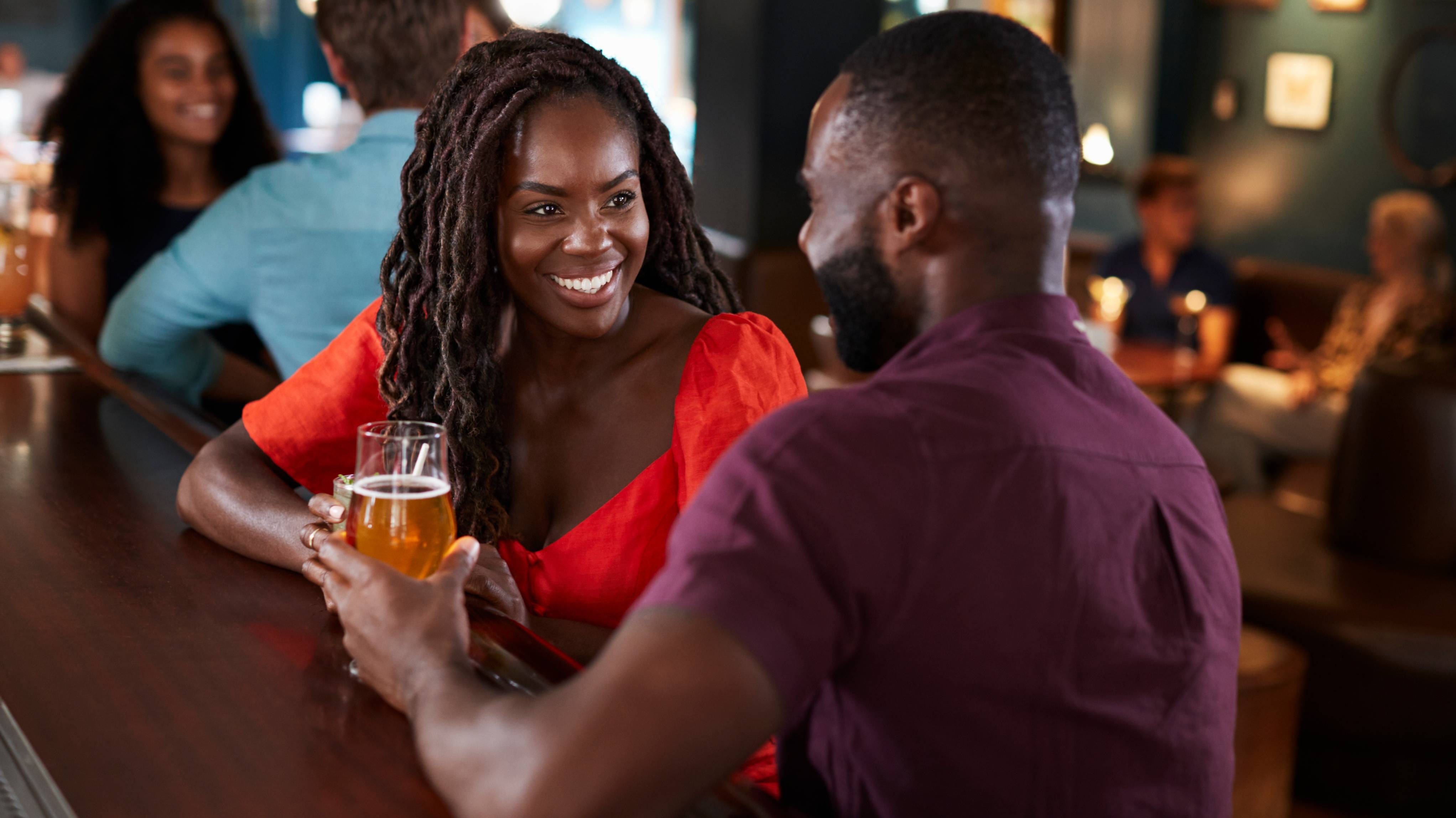 Couple On Date Sitting At Bar Counter And Talking.
