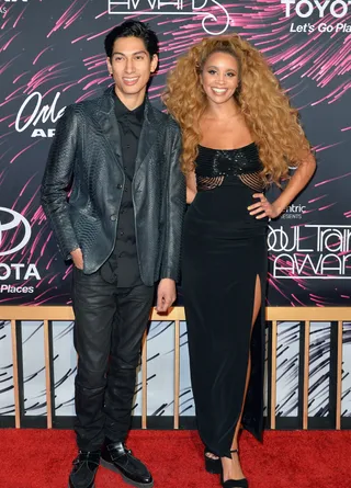 Perfect Pairing - Lucas Goodman and Jillian Hervey of Lion Babe coordinate in black with a touch of snakeskin for him and sparkle for her – but it's her hair that's the mane attraction. (Photo: Earl Gibson/BET/Getty Images for BET)