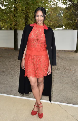 Ciara - The singer rocks the fall overcoat trend with a red lace dress and matching pumps at the Valentino show during Paris Fashion Week.&nbsp;(Photo: Pascal Le Segretain/Getty Images)