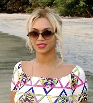 Beyoncé - Bey lightens up with some more blonde highlights. Her cascading curls and pretty pink lipstick make up her picture-perfect sun-kissed look. By Metanoya Z. Webb (Photo: iam.beyonce via Tumblr)