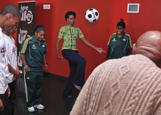 She’s Got Skills - Obama displays some of her soccer talents as she kicks around a ball with young participants.(Photo: AP Photo/Charles Dharapak, Pool)