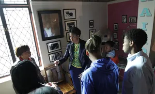 Barbershop Stop - The first lady tours a recreated barber shop at the museum. (Photo: AP Photo/Charles Dharapak, Pool)