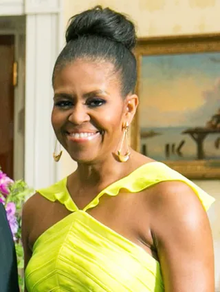 Michelle Obama  - Our First Lady is so damn fly! Here she opts for an elegant bun accented with a smoky eye and contoured cheeks — pretty!  (Photo: Stringer/Anadolu Agency/Getty Images)