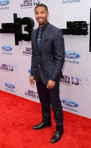 Dapper - Fruitvale star Michael B. Jordan knows how to wear a suit. The young actor steps out in navy and black.   (Photo: Jason Merritt/BET/Getty Images for BET)