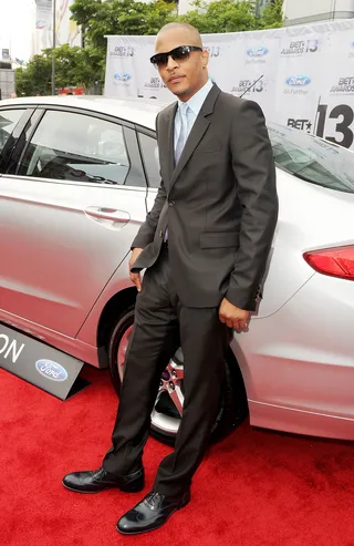 Ballin' - Everyone wants to take a gangsta car pose photo and rapper T.I. doesn't disappoint in his designer suit.  (Photo: Kevin Winter/BET/Getty Images for BET)