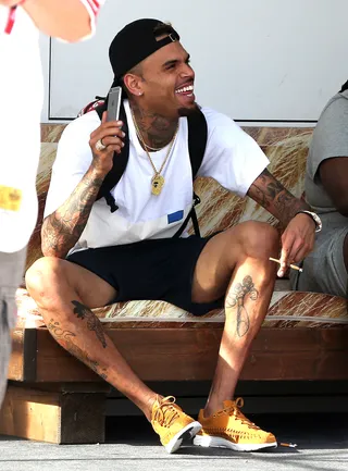 Pre-Work Fun - Chris Brown was spotted laughing it up as he played with his phone ahead of his performance at the Fresh Island Festival 2016 in Croatia (Photo: WENN.com)