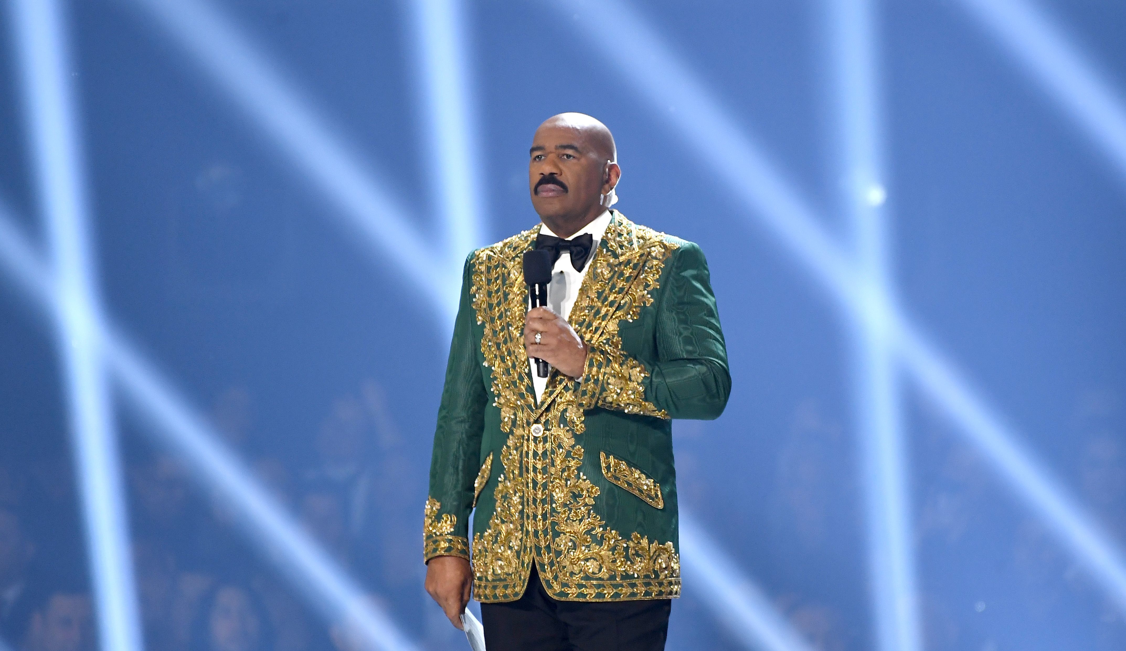 ATLANTA, GEORGIA - DECEMBER 08: (EDITORIAL USE ONLY) Steve Harvey speaks onstage during 2019 Miss Universe Pageant at Tyler Perry Studios on December 08, 2019 in Atlanta, Georgia. (Photo by Paras Griffin/Getty Images)