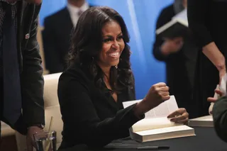 Chic In All Black&nbsp; - Michelle stops by the Seminary Co-op&nbsp;bookstore in Chicago to greet fans and sign copies of her book (Nov. 13). She's chic in an all-black suit (Photo: Scott Olson/Getty Images)