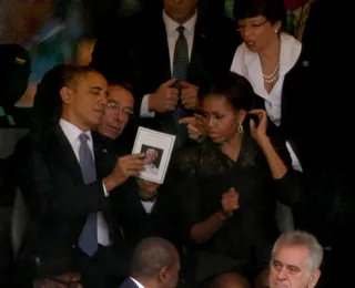 President Obama and First Lady Michelle Obama look at a the program honoring the late leader.(Photo: Chip Somodevilla/Getty Images)