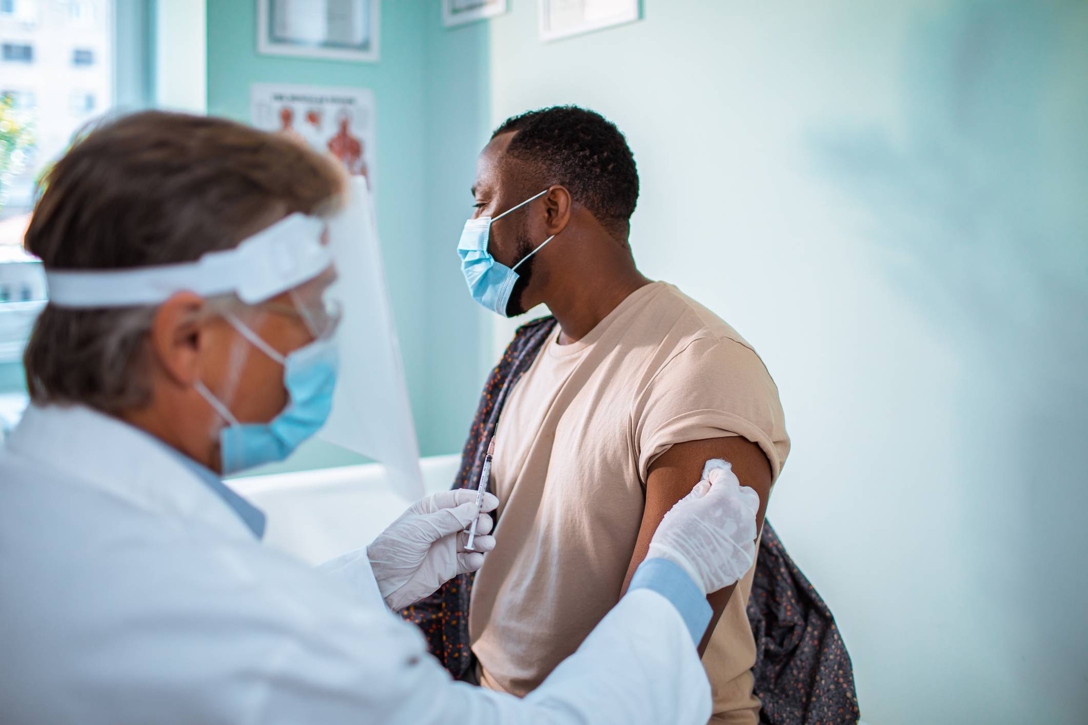 Close up of a young man getting vaccinated