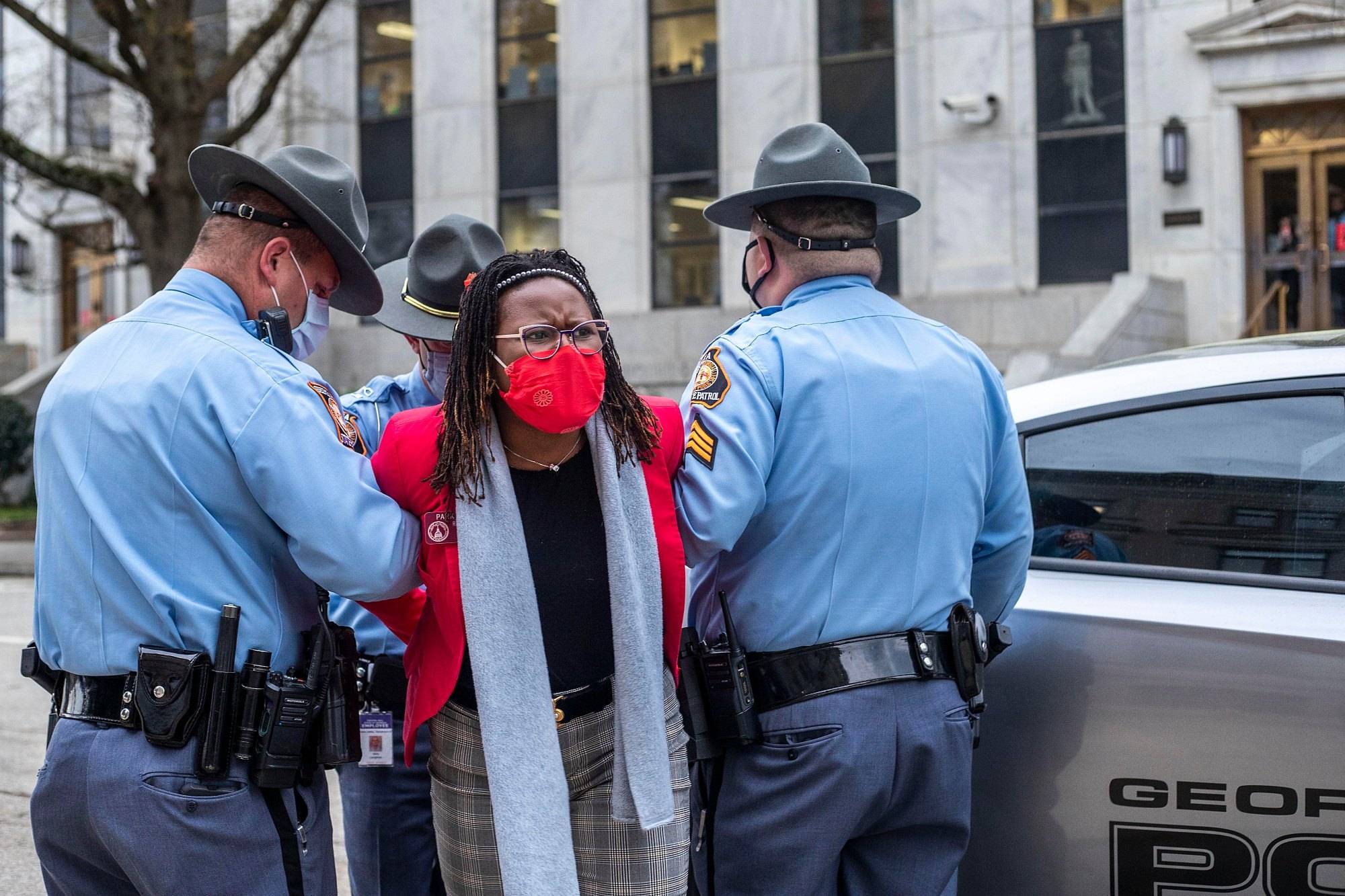 03/25/2021 —Atlanta, Georgia — Rep. Park Cannon (D-Atlanta) is placed into the back of a Georgia State Capitol patrol car after being arrested by Georgia State Troopers on day 38 of the legislative session at the Georgia State Capitol Building in Atlanta, Thursday, March 25, 2021. (Alyssa Pointer / Alyssa.Pointer@ajc.com)