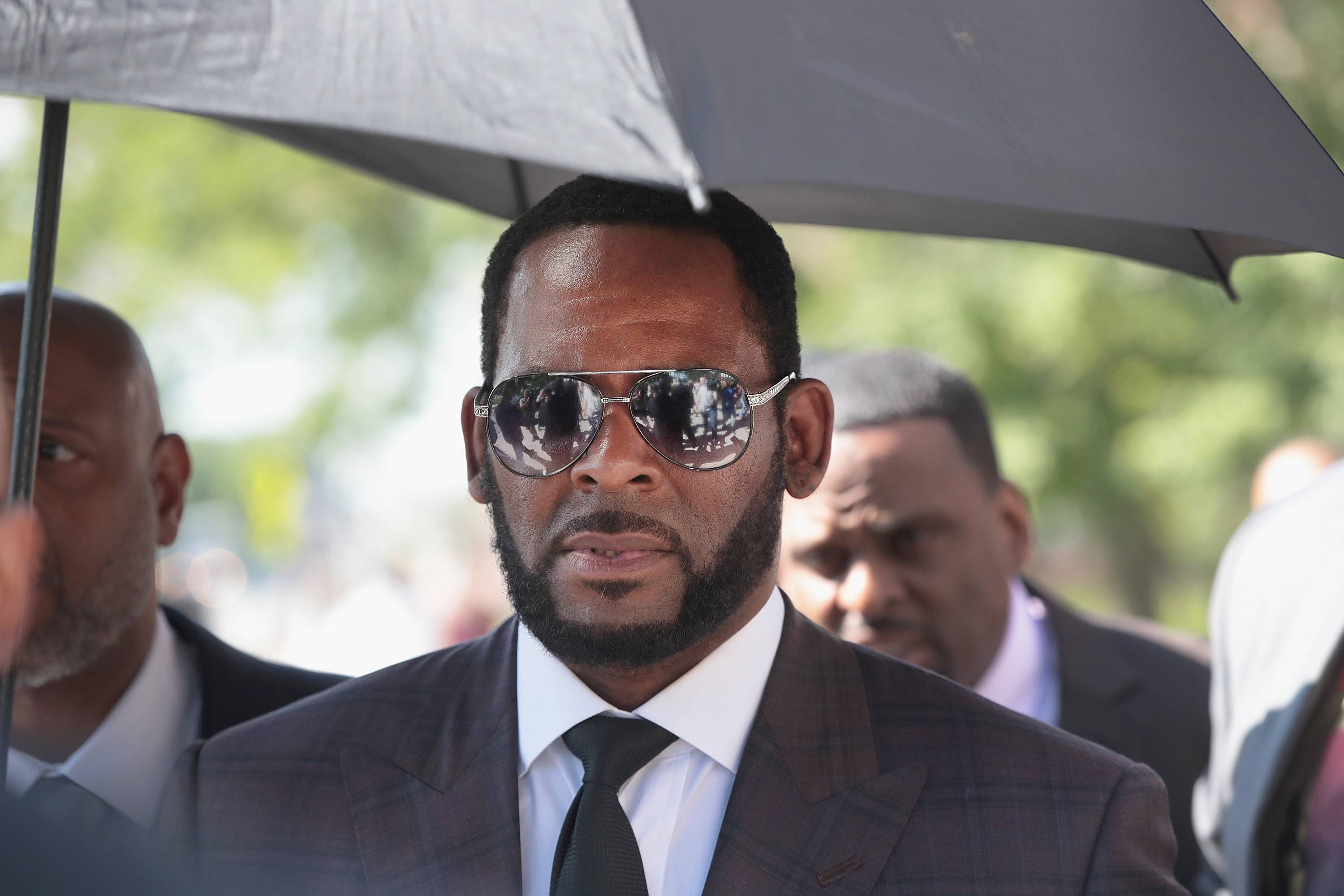 CHICAGO, ILLINOIS - JUNE 26: R&B singer R. Kelly leaves the Leighton Criminal Courts Building following a hearing on June 26, 2019 in Chicago, Illinois. Prosecutors turned over to Kelly's defense team a DVD that alleges to show Kelly having sex with an underage girl in the 1990s. Kelly has been charged with multiple sex crimes involving four women, three of whom were underage at the time of the alleged encounters. 
 (Photo by Scott Olson/Getty Images)