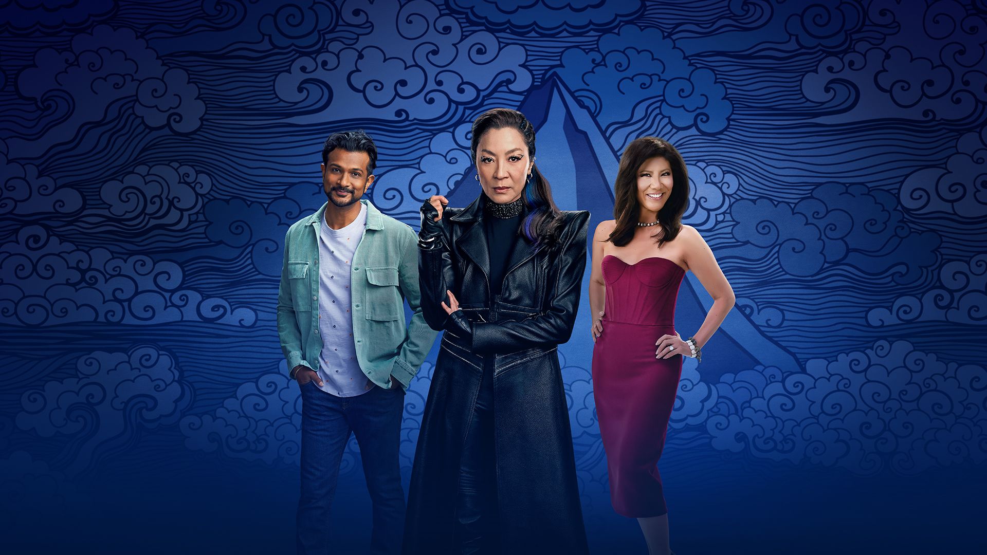 Utkarsh Ambudkar of "Ghosts," Michelle Yeoh of "Star Trek: Section 31," and "Big Brother" host Julie Chen Moonves in front of a blue mountainous and windy AAPI month thematic backdrop.