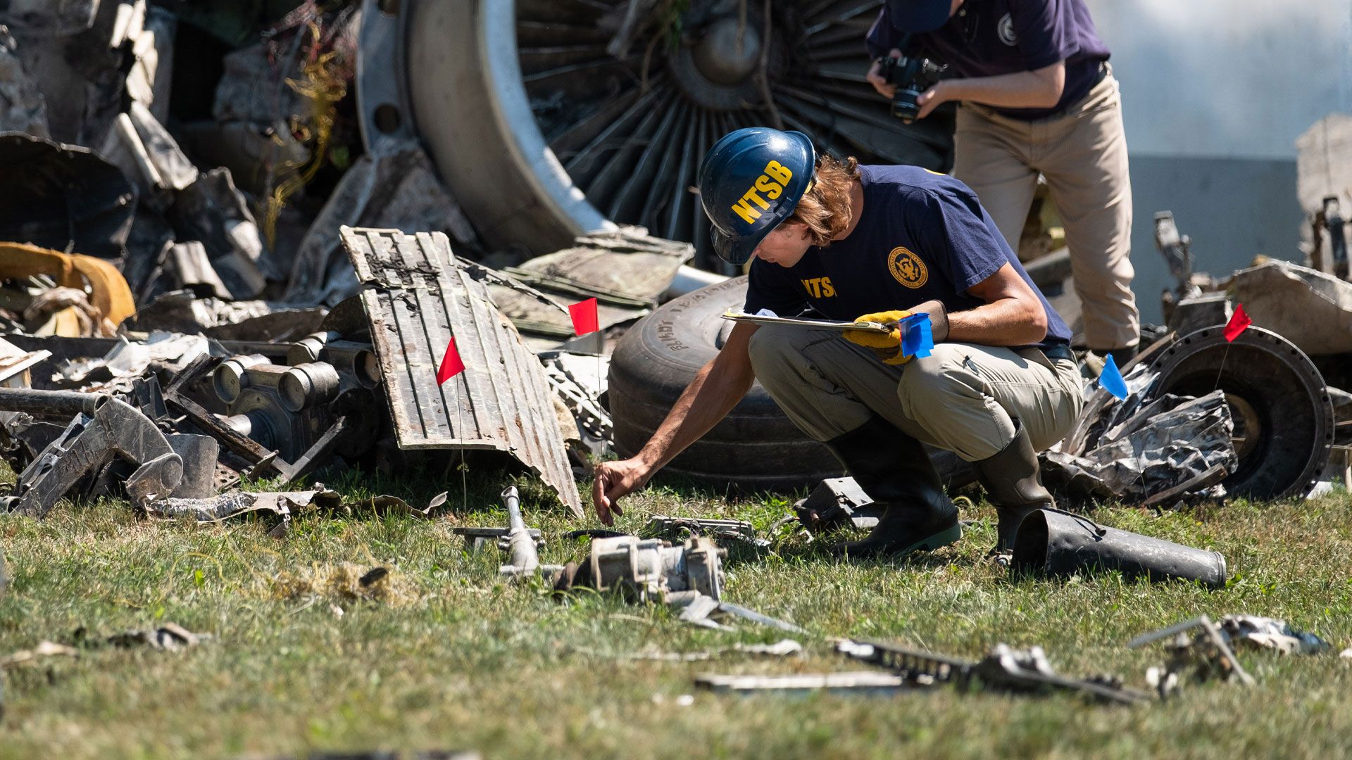 A National Transportation Safety Board investigator takes notes at <a href=